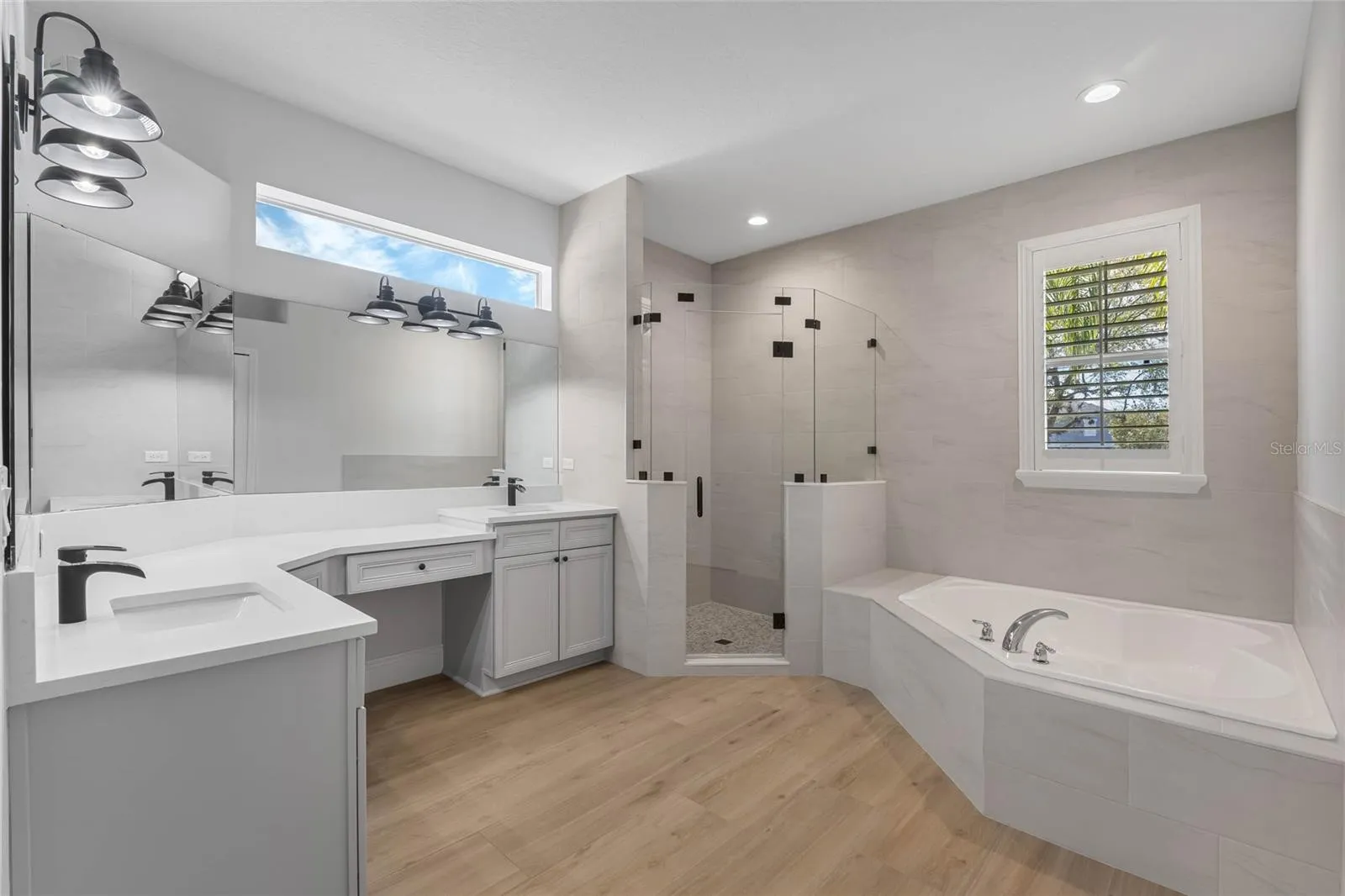 primary bathroom with step in shower and large tub